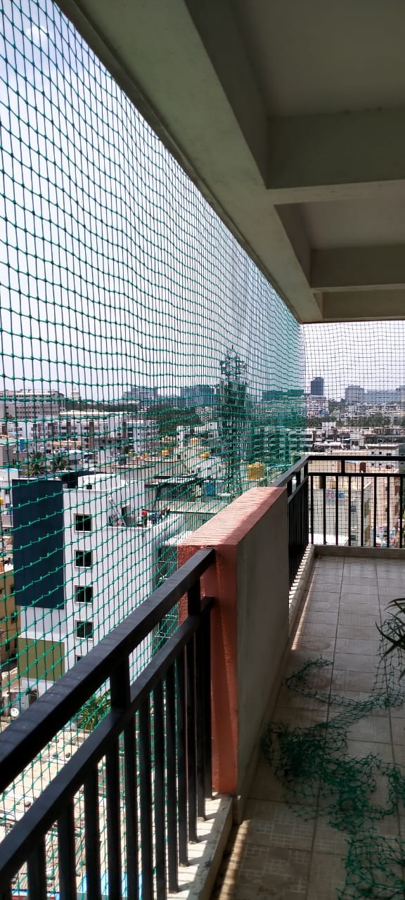 Ground floor bird net fitted over a balcony and garden area