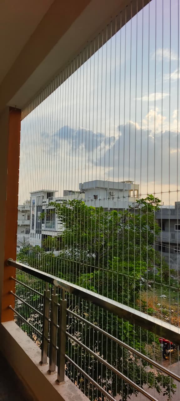 Floor-to-ceiling invisible grill on a balcony with open sky view