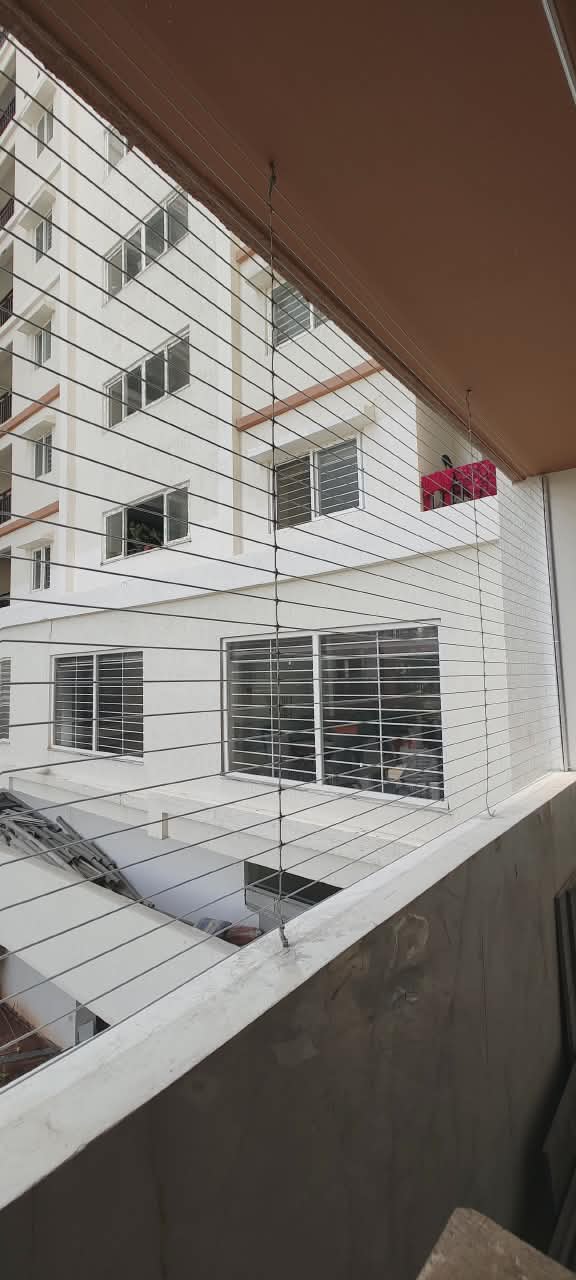 Invisible grill wires seen against an apartment building facade