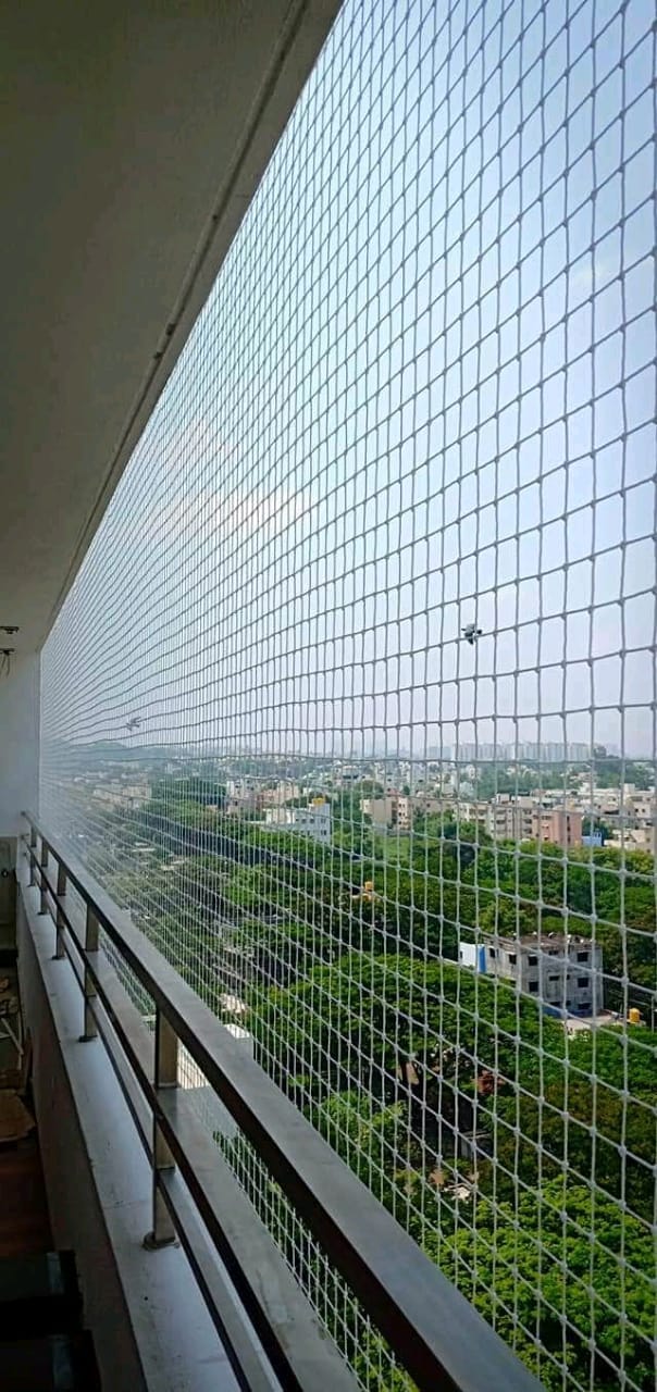White safety net covering a covered balcony with roof sheet